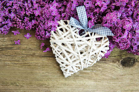 Lilac flowers on a white wooden background