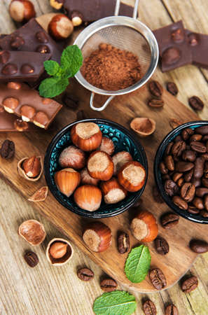 Chocolate and nuts on a old wooden tableの写真素材