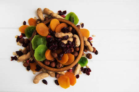 Mixed dried fruits on a old white wooden tableの写真素材