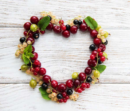 heart made from berries on a old wooden tableの写真素材
