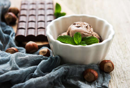 Bowl with chocolate ice cream on a old wooden backgroundの写真素材