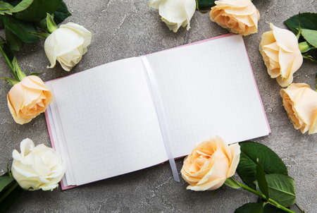 Roses and notebook on a concrete backgroundの写真素材