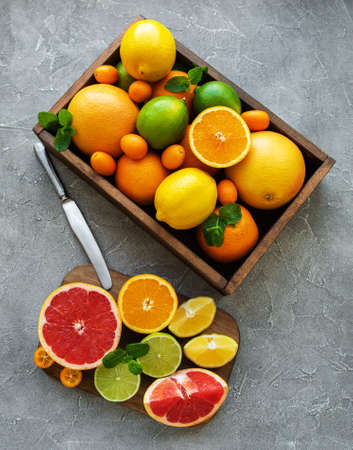 box with citrus fresh fruits on a concrete background