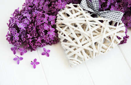 Lilac flowers on a white wooden background