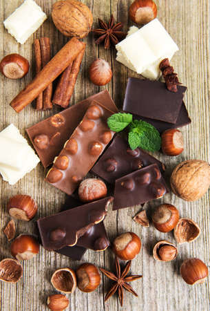 Chocolate and nuts on a old wooden table