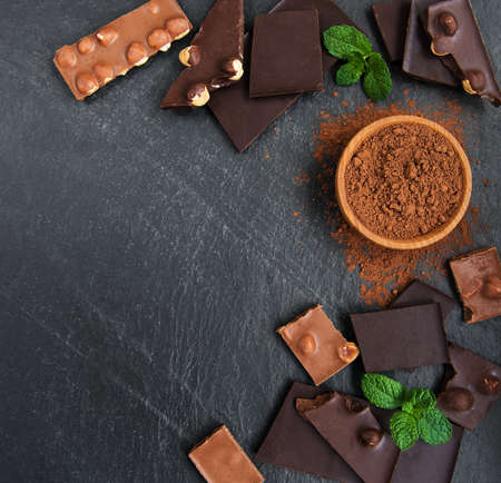 Chocolate with  nuts on a black stone background