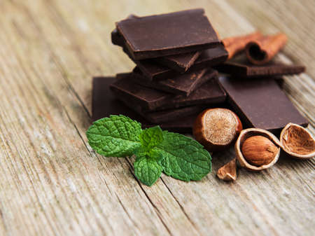 Chocolate with hazelnuts  on a old wooden table