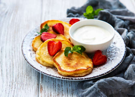 Delicious pancakes with strawberry on white wooden backgroundの写真素材