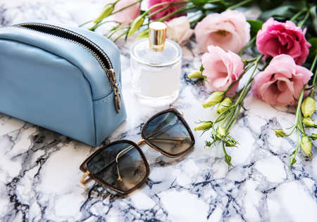 Leather cosmetic bag with accessories on a marble background
