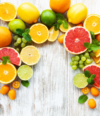 citrus fresh fruits on a old wooden backgroundの写真素材
