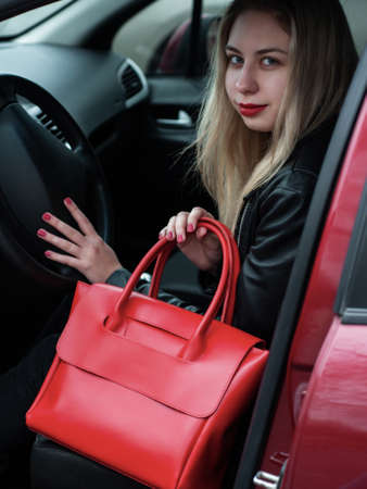 beautiful caucasian girl with a red leather bag