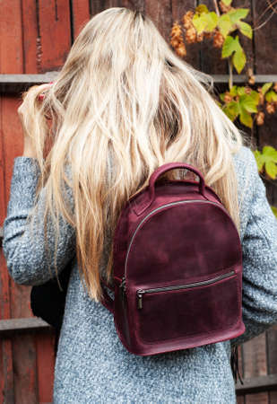 Beautiful Caucasian girl with a leather backpackの写真素材