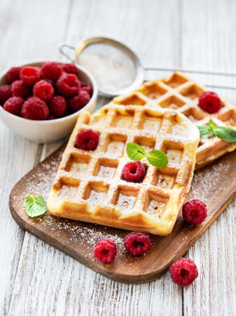 Homemade waffles with berries in plate on a old woodenの写真素材