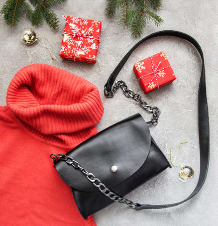 Black leather bag with Christmas decorations - flat layの写真素材