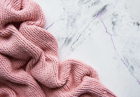 Pink knited sweater on a marble backgroundの写真素材
