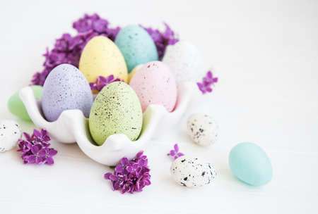 Easter eggs in tray with lilac flowers