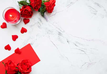 Valentines day romantic background - red roses, candle and heartsの写真素材