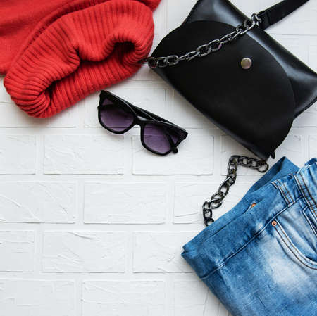 Black leather bag with  sweater and jeans - flat layの写真素材