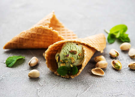 pistachio ice cream and mint with pistachio nuts on a stonebackground