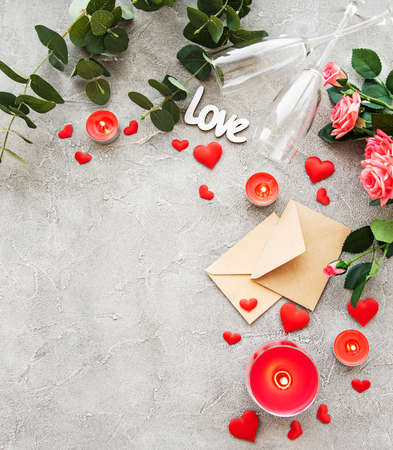 Valentines day romantic background - red roses, glasses, candle and heartsの写真素材