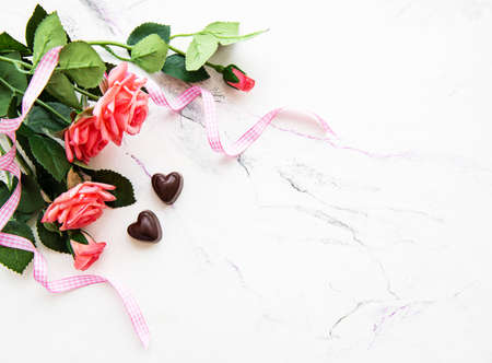 Valentines day romantic background -  chocolate candy and roses on a marble  backgroundの写真素材