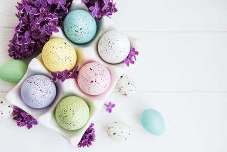 Easter eggs in tray with lilac flowers