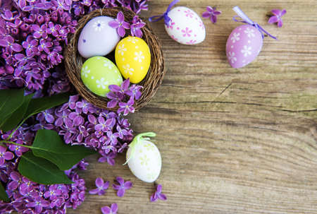 Nest with  easter eggs and spring lilac flowers