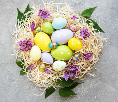 Nest with  easter eggs and spring lilac flowers