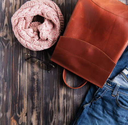 Brown leather backpack on a old wooden backgroundの写真素材