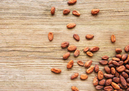 Raw cacao beans on an old wooden  backgroundの写真素材