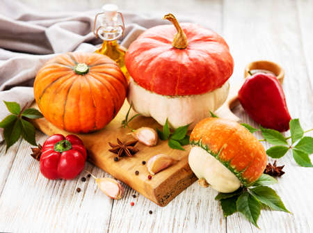 Autumn arrangement of pumpkins on a old wooden tableの写真素材