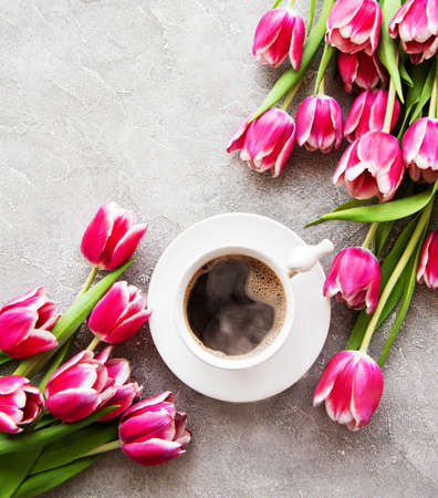 Cup of coffee and tulips on a concrete backgroundの写真素材