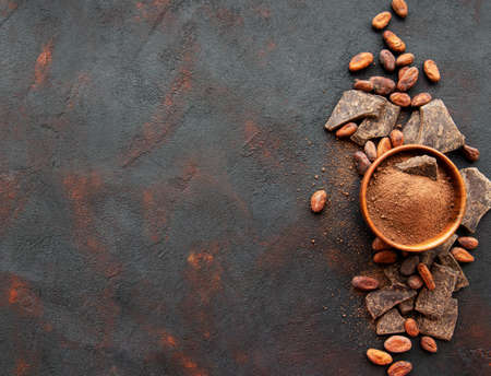 Natural  cocoa powder and cocoa beans  on a blackの写真素材