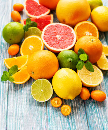 Fresh citrus fruits on a old wooden backgroundの写真素材