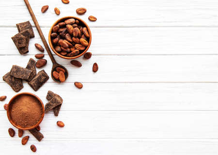 Natural  cocoa powder and cocoa beans  on a wooden backgroundの写真素材