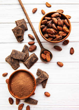 Natural  cocoa powder and cocoa beans  on a wooden backgroundの写真素材
