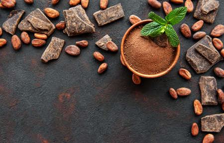 Natural  cocoa powder and cocoa beans  on a black backgroundの写真素材
