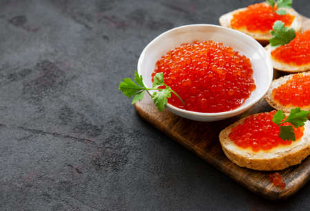 Sandwiches with red caviar on a black concrete backgroundの写真素材