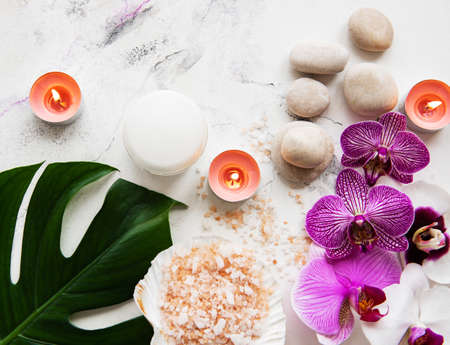 Natural spa ingredients with orchid flowers on a white marble backgroundの写真素材