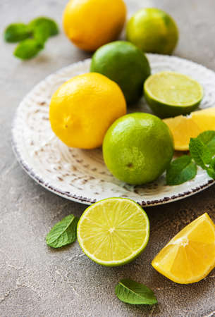 Plate with lemons and limes on concrete backgroundの写真素材