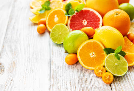 Fresh citrus fruits on an old wooden backgroundの写真素材