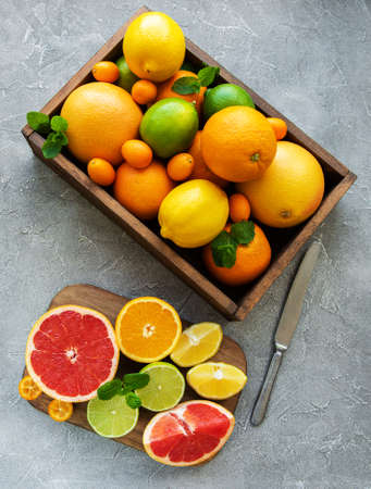 box with citrus fresh fruits on a concrete backgroundの写真素材