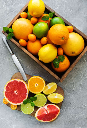 box with citrus fresh fruits on a concrete backgroundの写真素材
