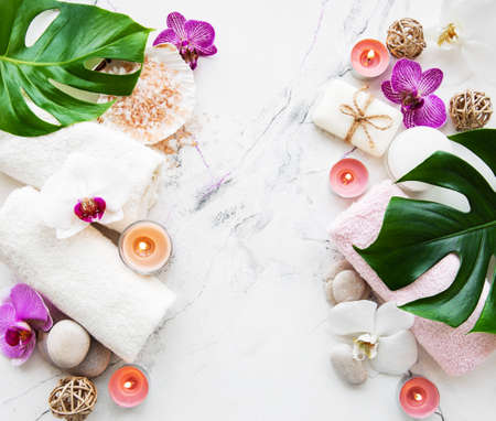 Natural spa ingredients with orchid flowers on a white marble backgroundの写真素材