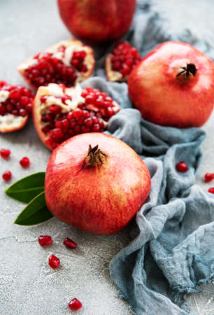 Ripe pomegranate fruits on  grey concrete backgroundの写真素材