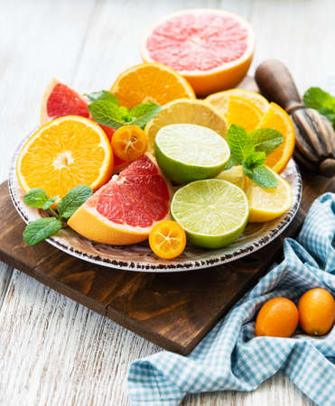 Fresh citrus fruits on a old wooden tableの写真素材