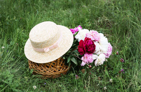 Beautiful bouquet of bright peony  flowers in basketの写真素材