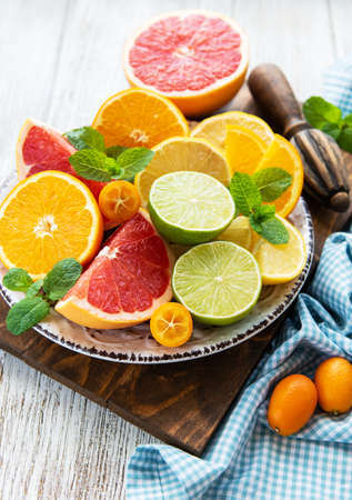 Fresh citrus fruits on a old wooden tableの写真素材