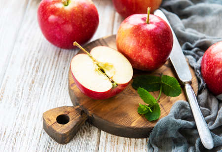 Fresh red apples on a old white wooden backgroundの写真素材