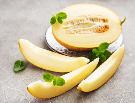 Plate with melon on a concrete backgroundの写真素材